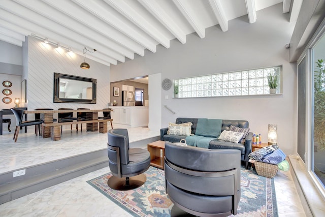 living room featuring vaulted ceiling with beams