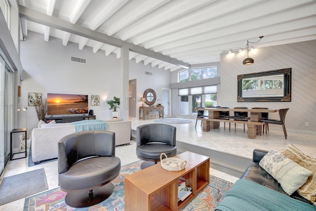 living room with lofted ceiling with beams