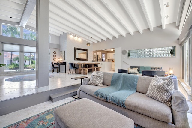 tiled living room with vaulted ceiling with beams