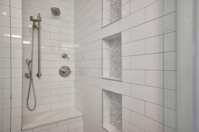 bathroom with a tile shower