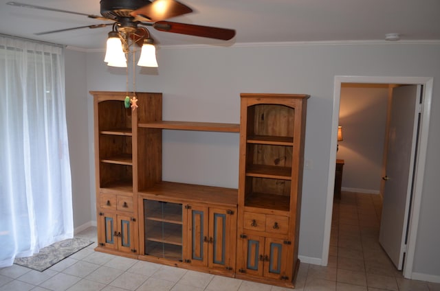 unfurnished living room featuring ceiling fan, light tile patterned floors, and crown molding