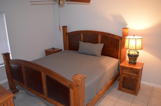 bedroom with ceiling fan and light tile patterned flooring