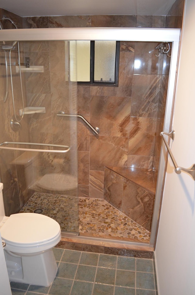 bathroom featuring an enclosed shower and toilet