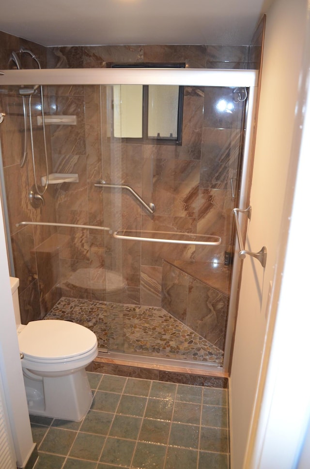 bathroom with an enclosed shower and toilet