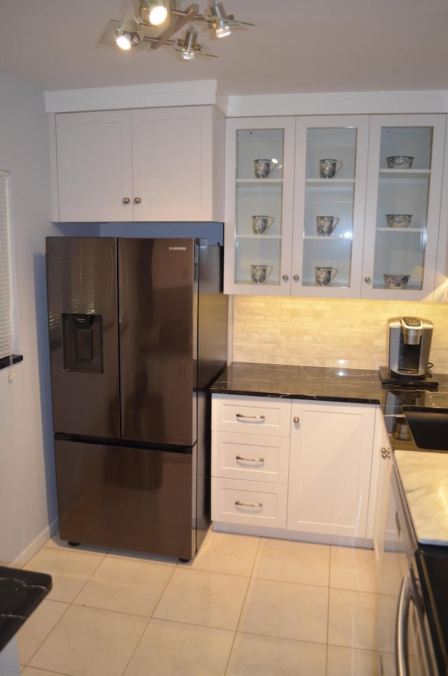 kitchen featuring white cabinets, decorative backsplash, and fridge with ice dispenser