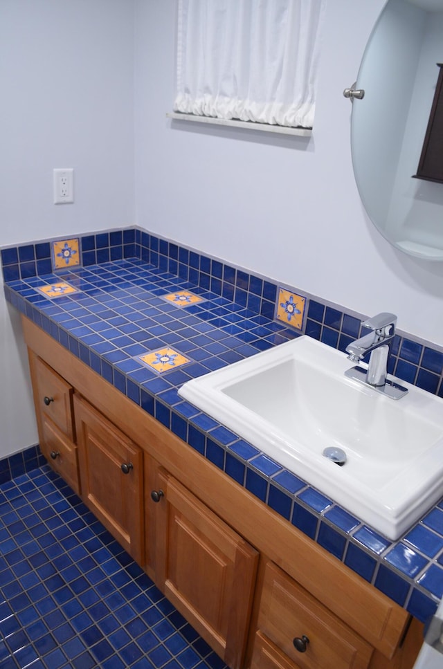 bathroom with tile patterned flooring, vanity, and tasteful backsplash