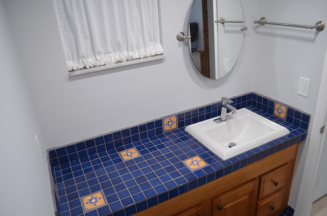 bathroom with vanity and tasteful backsplash