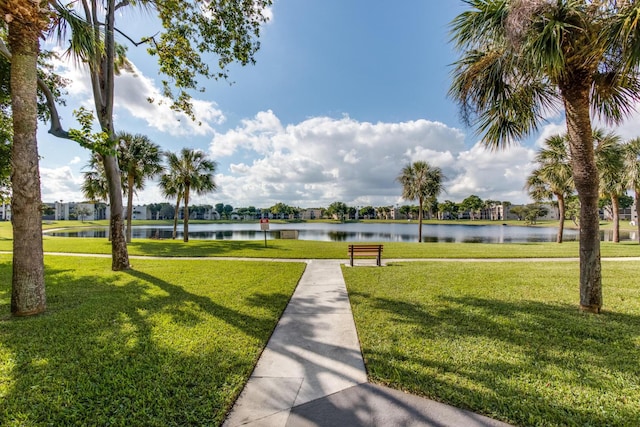 view of home's community featuring a water view and a yard