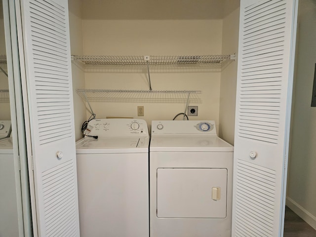 clothes washing area with wood-type flooring and washer and clothes dryer