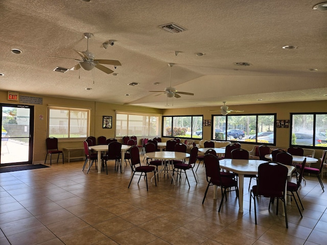 tiled dining room featuring lofted ceiling