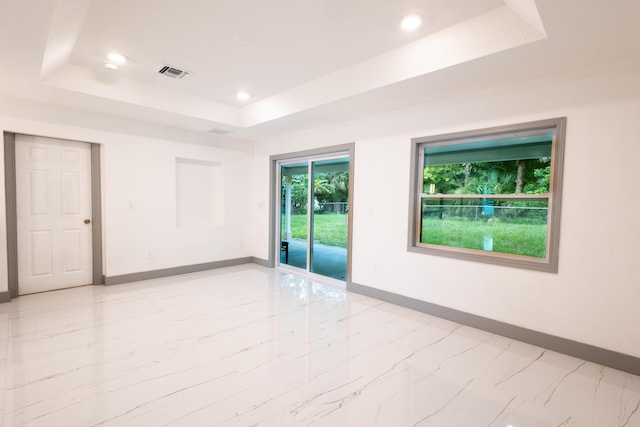 spare room featuring a raised ceiling