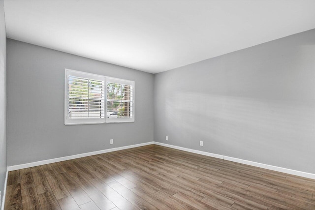 empty room with hardwood / wood-style flooring