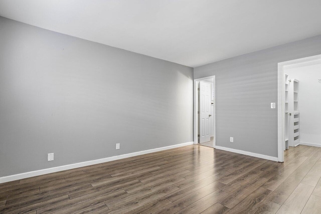 spare room with dark hardwood / wood-style flooring