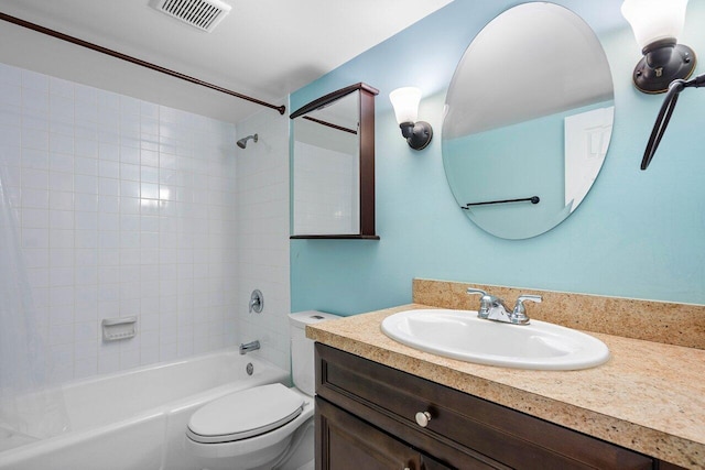 full bathroom featuring tiled shower / bath combo, toilet, and vanity