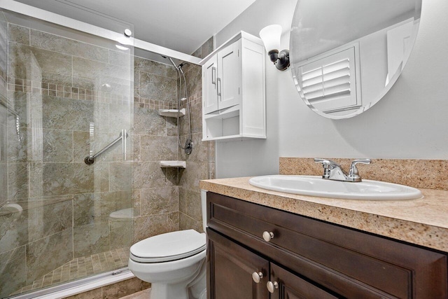 bathroom featuring an enclosed shower, vanity, and toilet