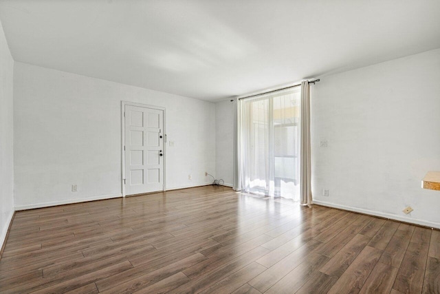 empty room featuring dark wood-type flooring