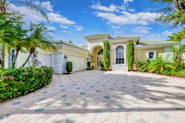 mediterranean / spanish-style house featuring a garage