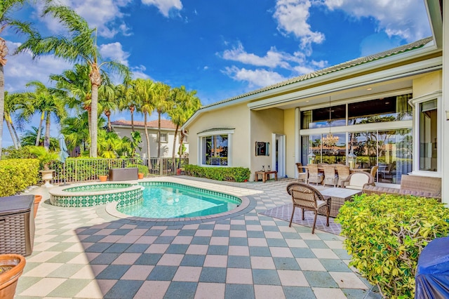 view of swimming pool featuring an in ground hot tub and a patio