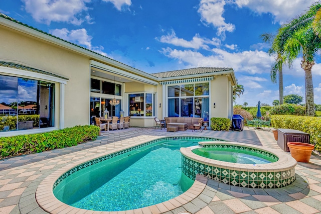 view of swimming pool featuring an in ground hot tub, a patio, and an outdoor hangout area