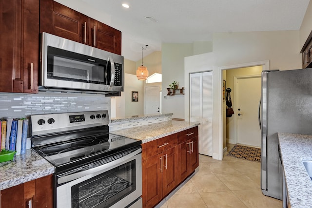 kitchen featuring appliances with stainless steel finishes, vaulted ceiling, hanging light fixtures, and light stone counters