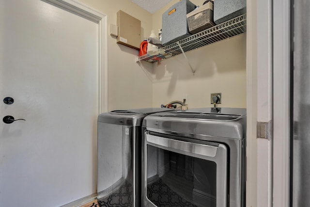 clothes washing area with laundry area and washing machine and clothes dryer