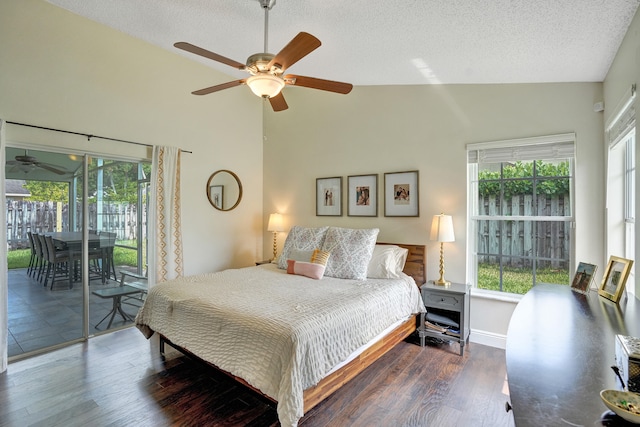 bedroom featuring dark wood finished floors, a ceiling fan, access to outside, a textured ceiling, and high vaulted ceiling