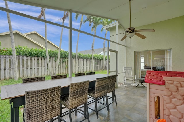 sunroom featuring a ceiling fan and a wealth of natural light