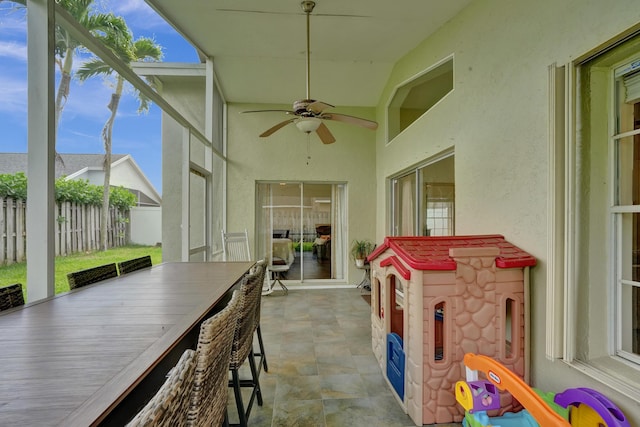 view of patio / terrace with ceiling fan and fence