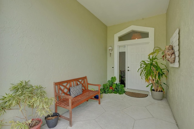 doorway to property featuring stucco siding