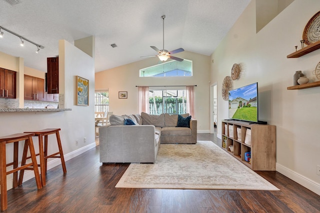 living area featuring track lighting, dark wood-style flooring, visible vents, and baseboards