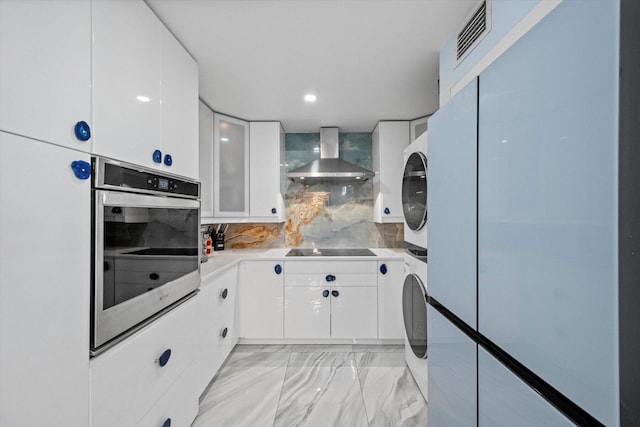 laundry area featuring stacked washer and dryer