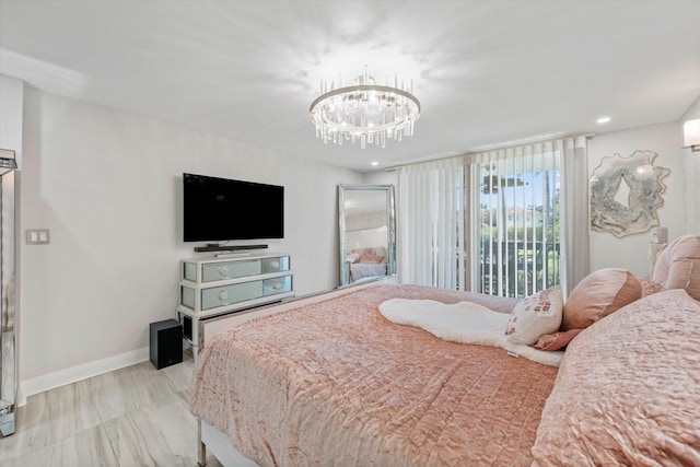 bedroom with a chandelier and connected bathroom