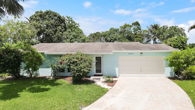 ranch-style home with a garage and a front lawn