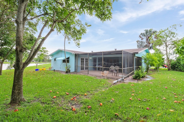 rear view of property with a patio and a yard