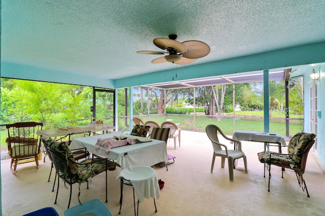 sunroom featuring ceiling fan