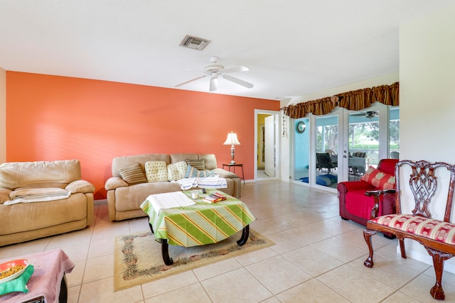 living room featuring tile floors, french doors, and ceiling fan