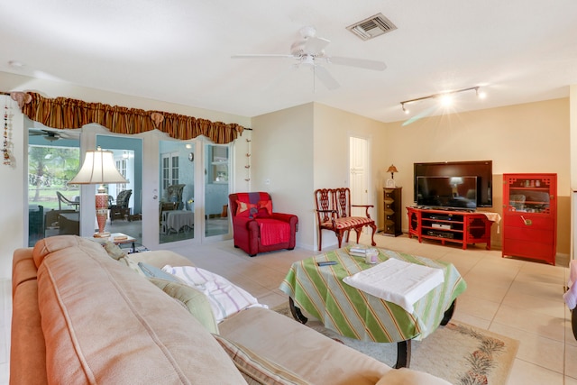 tiled living room featuring track lighting and ceiling fan