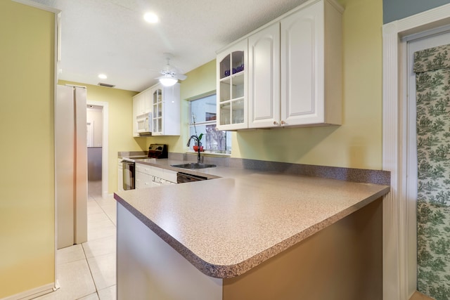 kitchen with white appliances, white cabinets, sink, ceiling fan, and light tile floors