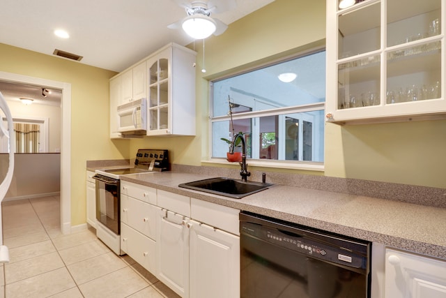 kitchen featuring white appliances, white cabinets, sink, light tile flooring, and ceiling fan