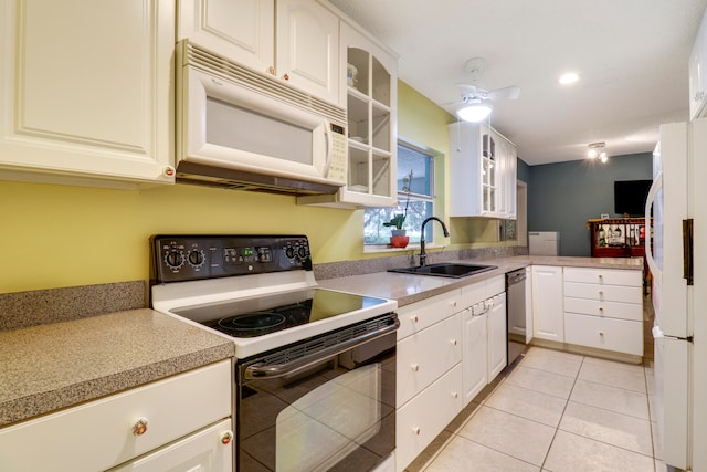 kitchen featuring white appliances, white cabinets, sink, ceiling fan, and light tile floors