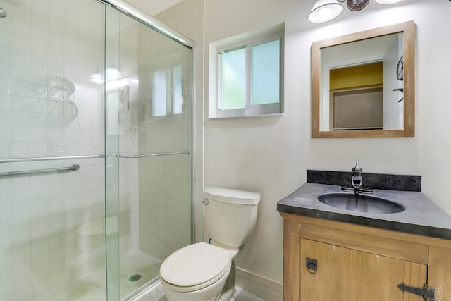 bathroom with an enclosed shower, oversized vanity, and toilet