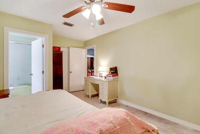 bedroom featuring ceiling fan, a closet, and a textured ceiling