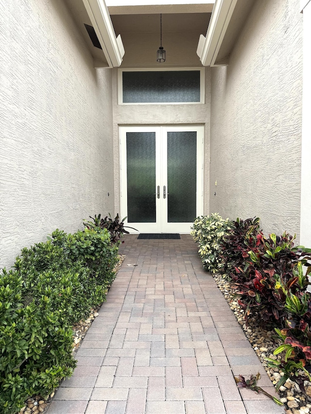 view of exterior entry featuring french doors