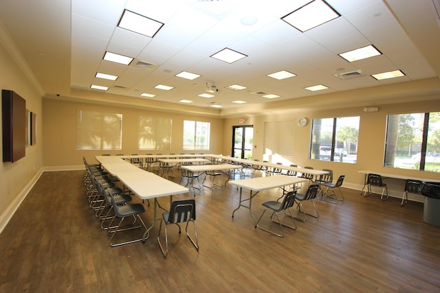 dining area featuring dark hardwood / wood-style floors, crown molding, and a healthy amount of sunlight