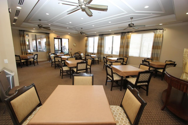 carpeted dining area with ceiling fan, coffered ceiling, and ornamental molding