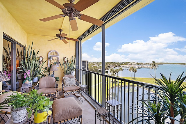 balcony with ceiling fan and a water view