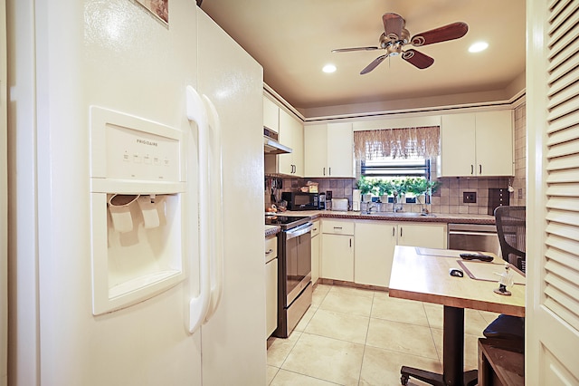 kitchen with white fridge with ice dispenser, tasteful backsplash, ceiling fan, range, and sink