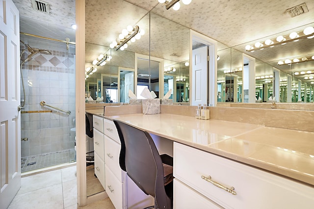 bathroom with walk in shower, tile flooring, and vanity