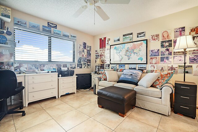 tiled home office featuring a textured ceiling and ceiling fan