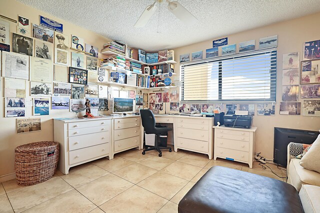 office with ceiling fan, light tile flooring, and a textured ceiling